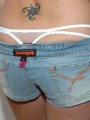 Kalees white thong is peeking out of her little jean shorts